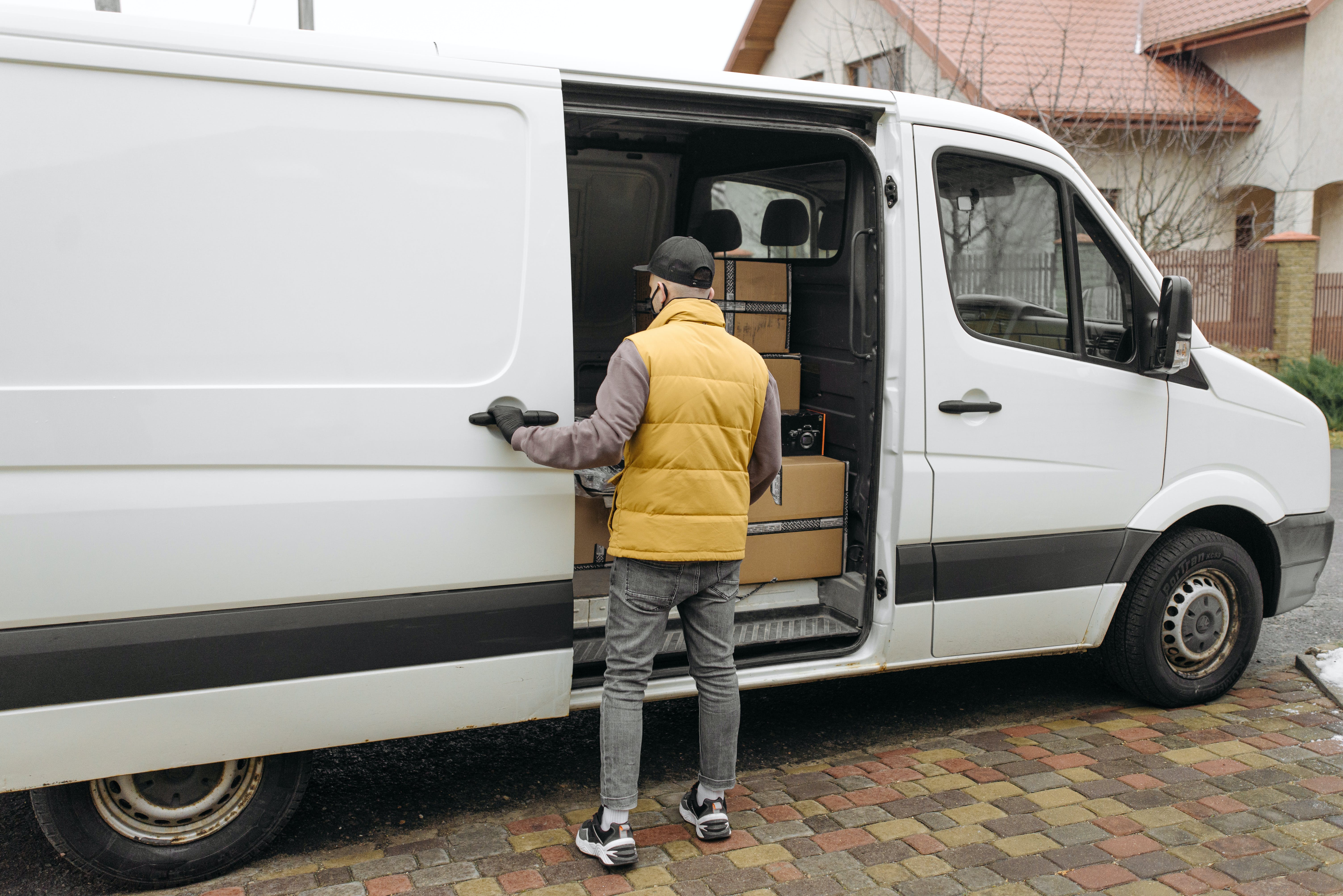 Free Man Opening a Door of a Delivery Van Stock Photo